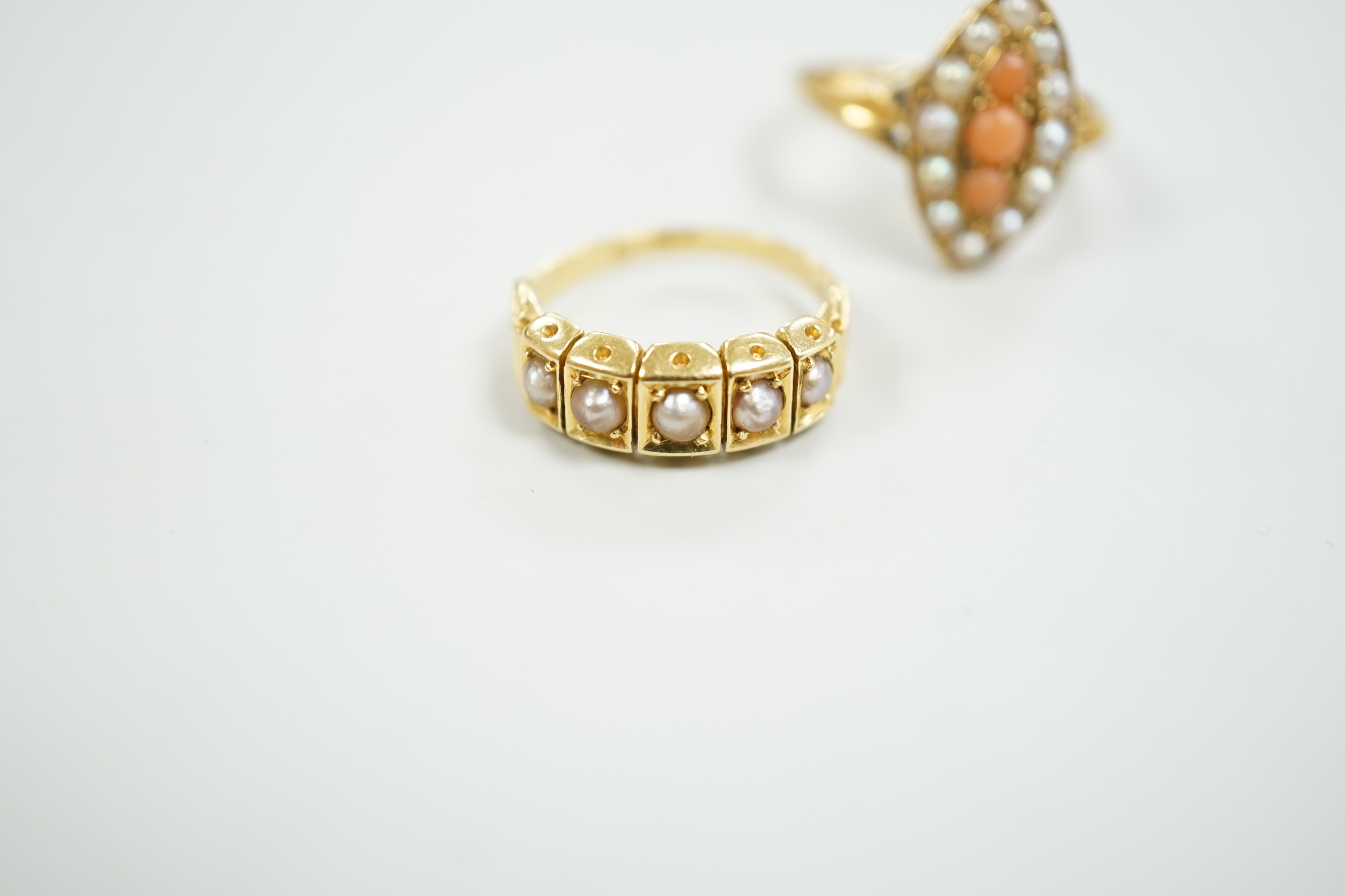 A late Victorian yellow metal, split pearl and coral set marquise shaped ring, size L and a similar yellow metal and split pearl set half hoop ring, gross weight 8 grams.